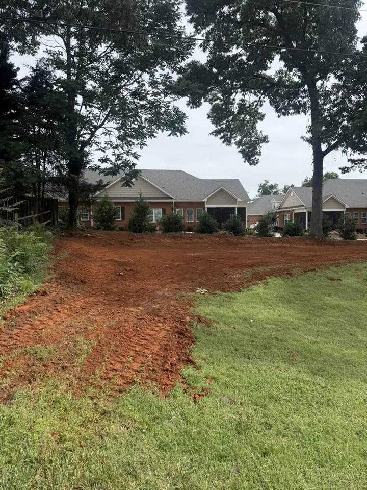 Backyard grading for proper drainage behind a home