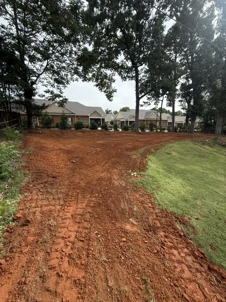 Freshly graded gravel driveway leading to a home
