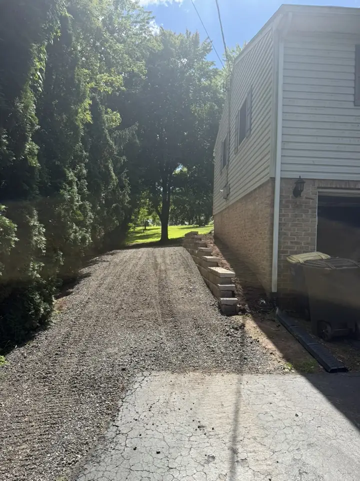 New gravel driveway installed beside a house