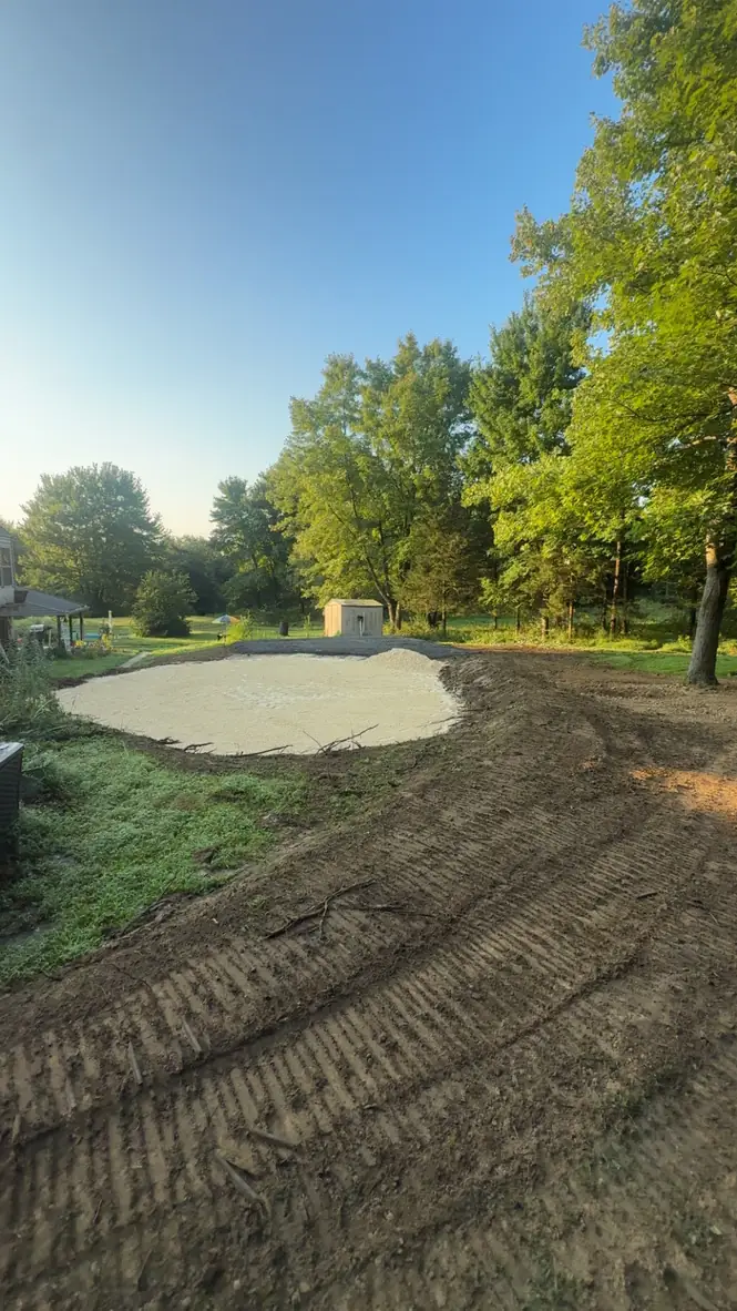 Compacted gravel pad prepared in a backyard