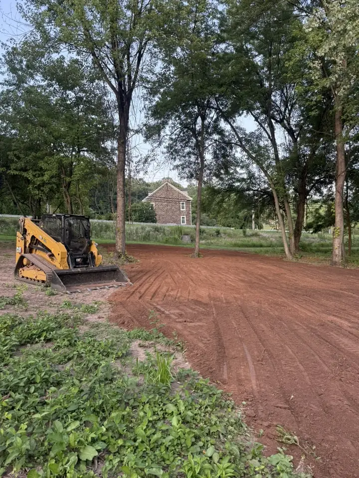 Skid steer grading a residential lot in Central PA