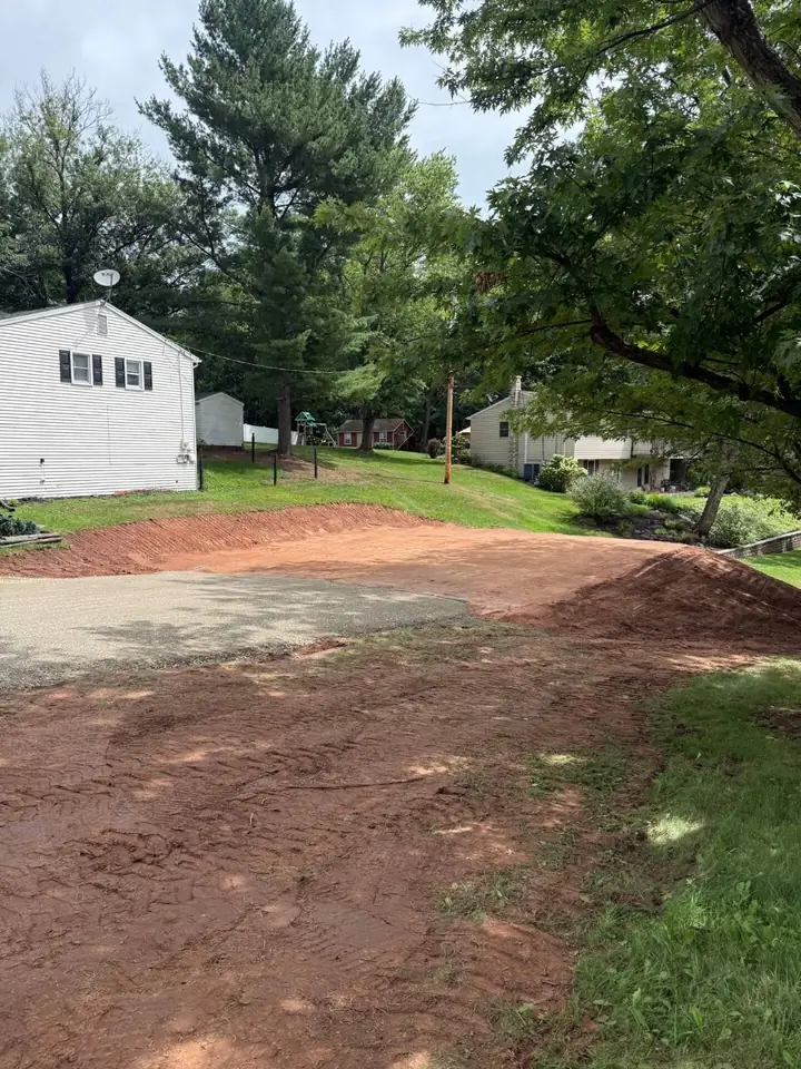 Graded and compacted pad prepared beside a home